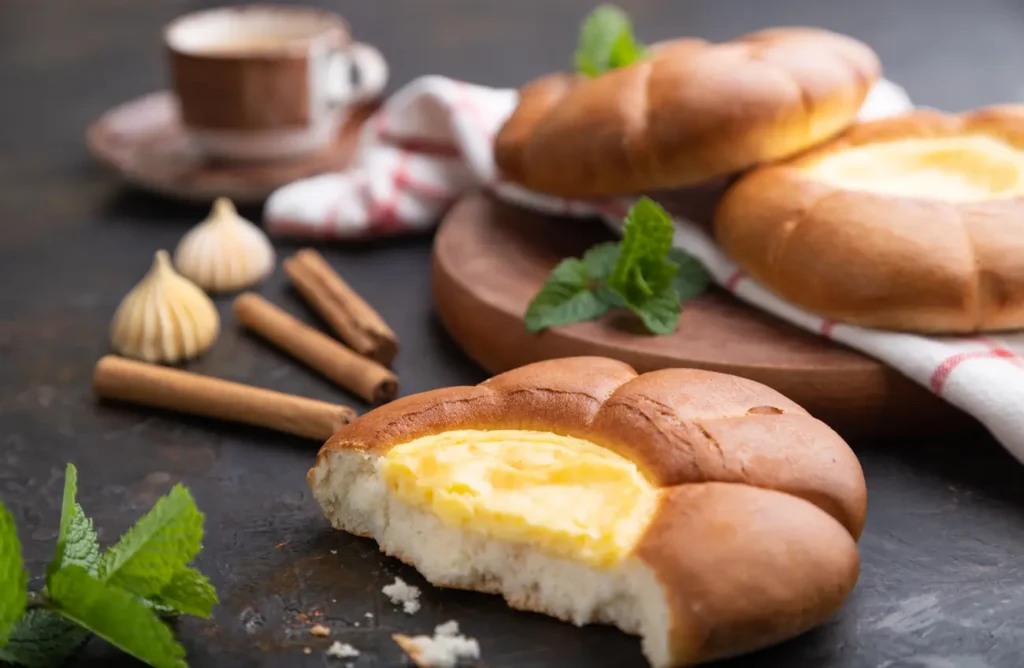 sour cream bun with cup of coffee on a black concr 2023 11 27 05 03 36 utc